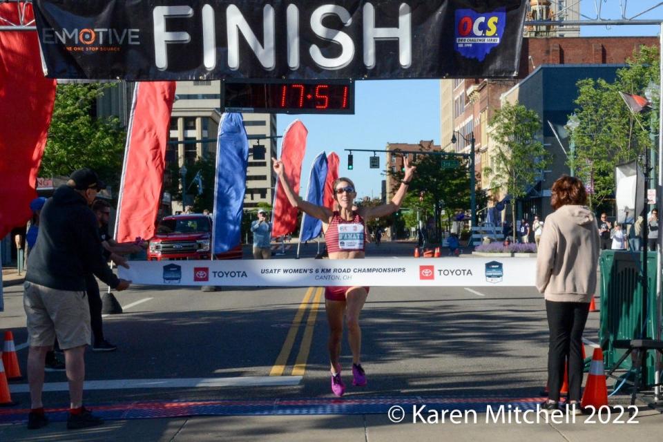 Keira D'Amato crosses the finish line to win the USA Track & Field Women's 6K Championships in Downtown Canton.