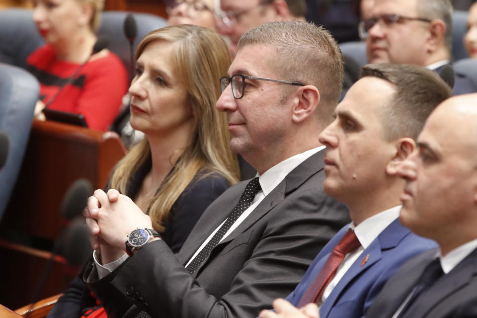 Hristijan Mickoski, center, the leader of the center-right VMRO DPMNE party which won the parliamentary elections on Wednesday, attends the inauguration ceremony of Gordana Siljanovska Davkova as a new President of North Macedonia, at the parliament building in Skopje, North Macedonia, on Sunday, May 12, 2024. Siljanovska Davkova has sworn as first female president in North Macedonia on Sunday after her triumph in a presidential runoff earlier this week over the leftist incumbent president. (AP Photo/Boris Grdanoski)