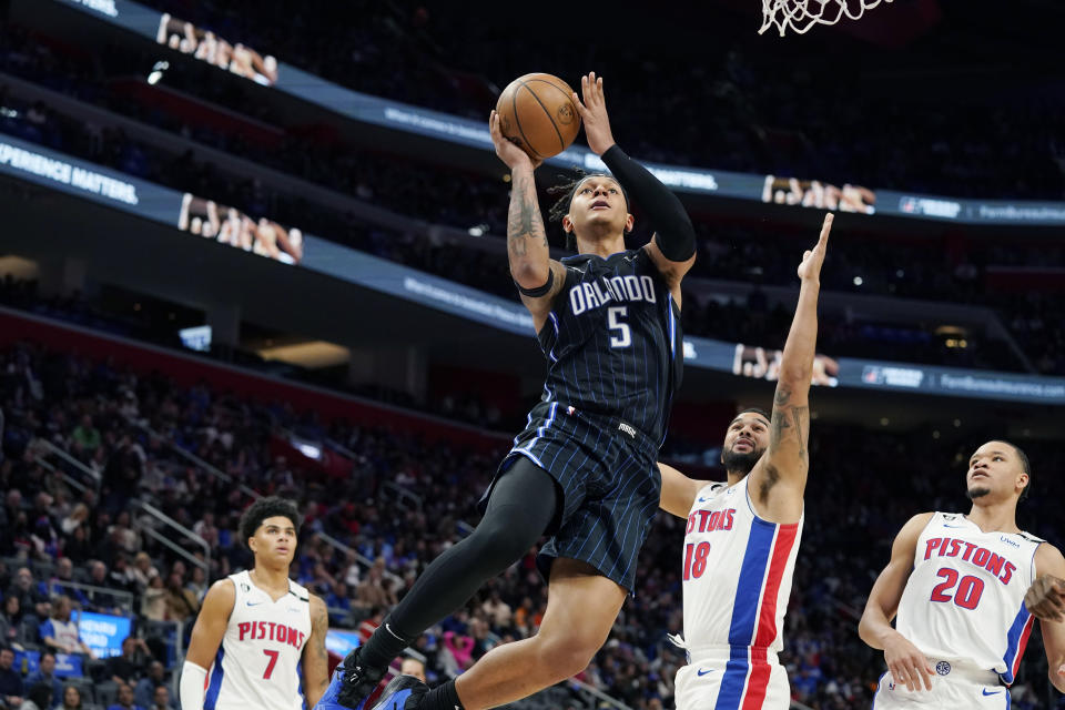 Orlando Magic forward Paolo Banchero (5) attempts a layup as Detroit Pistons guard Cory Joseph (18) defends during the second half of an NBA basketball game, Wednesday, Oct. 19, 2022, in Detroit. (AP Photo/Carlos Osorio)