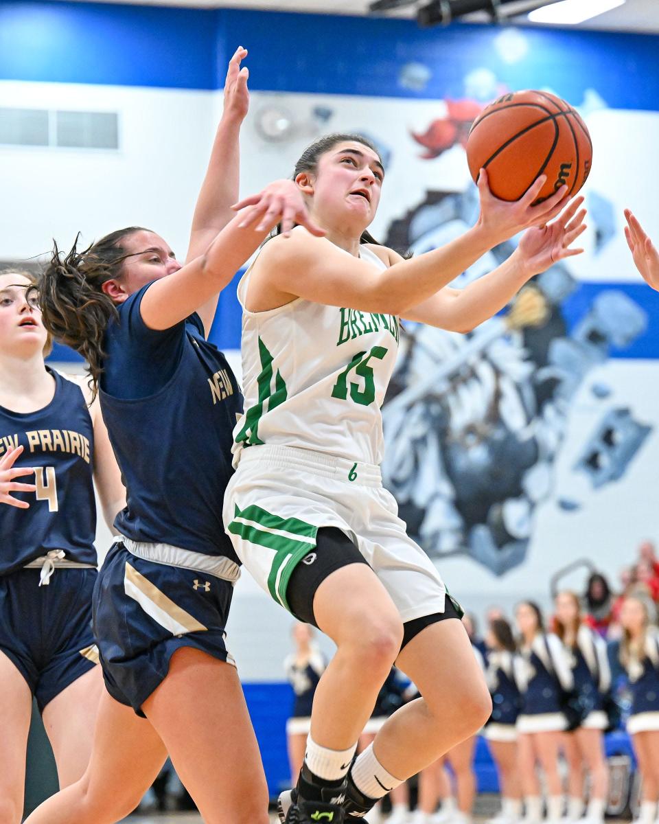 Bremen’s Ellia Foster (15) goes up for a shot as New Prairie’s Morgan White (33) defends in the fourth quarter of the TCU Bi-County Girls Varsity Finals Saturday, Jan. 22, 2022, at LaVille High School.