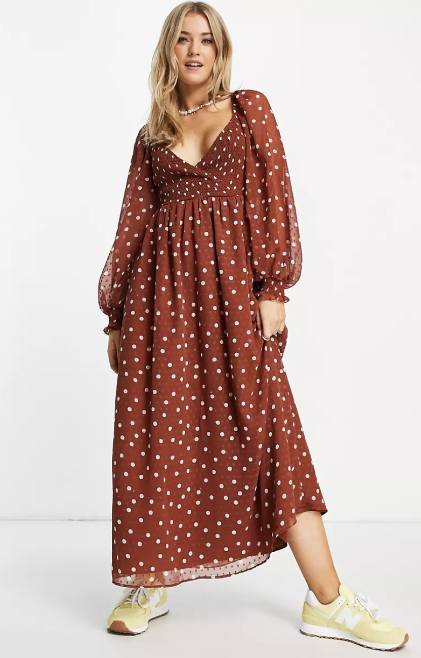 blonde model in brown and white polka dot ASOS Design Shirred Wrap Maxi Dress (Photo via ASOS)