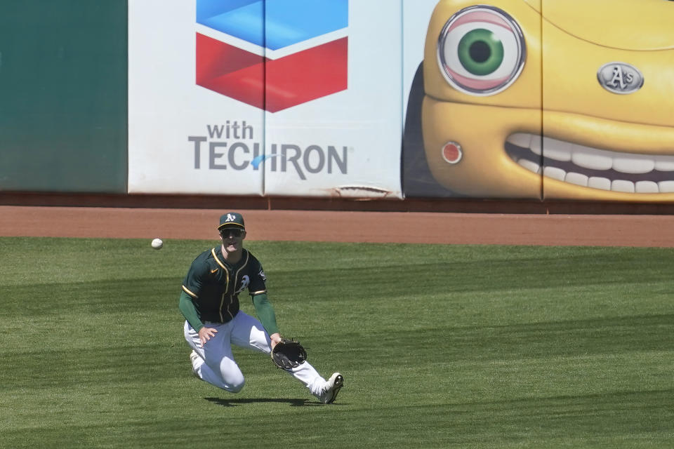 Oakland Athletics left fielder Mark Canha catches a line-out hit by Baltimore Orioles' Maikel Franco during the fifth inning of a baseball game in Oakland, Calif., Sunday, May 2, 2021. (AP Photo/Jeff Chiu)