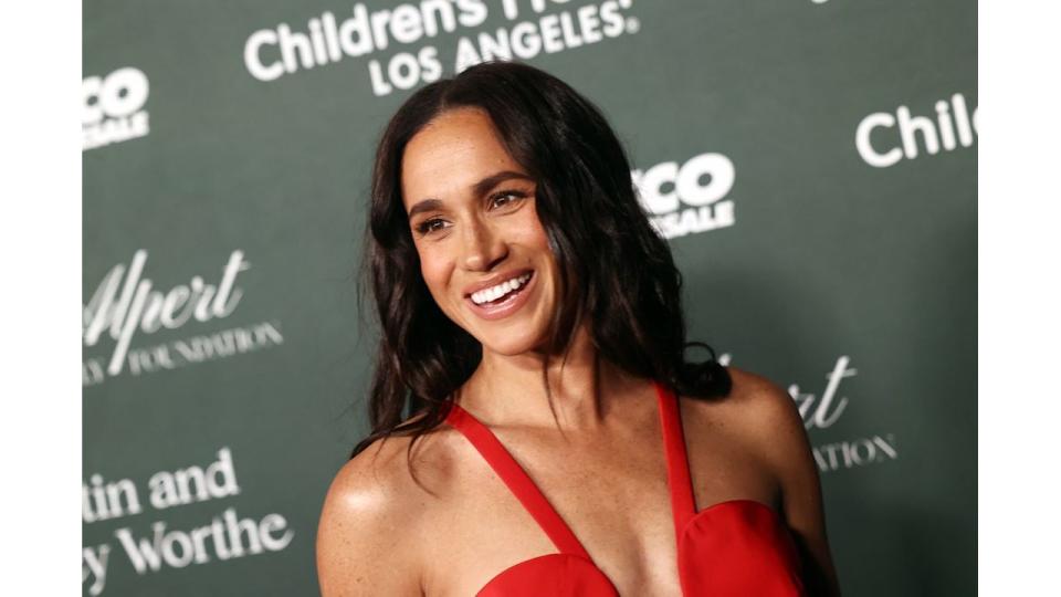 woman smiling in red dress at gala