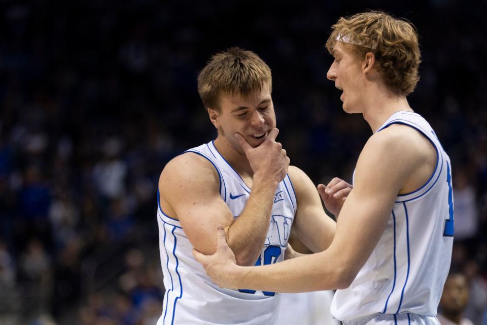 BYU guard, Dallin Hall (30) holds his jaw after being hit while BYU guard, Richie Saunders (15) talks to him during their game in Provo on Saturday, Jan. 27, 2024. BYU won 84-72. | Marielle Scott, Deseret News