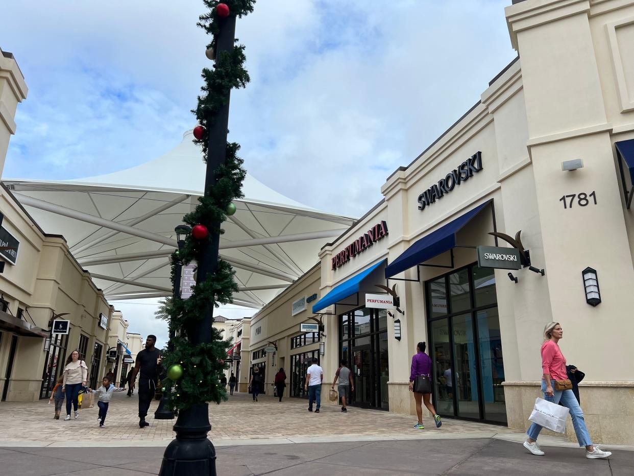 Shoppers at the Tanger Outlets in West Palm Beach. The open-air mall is packed with shoppers, many of them tourists, during the holiday shopping season.