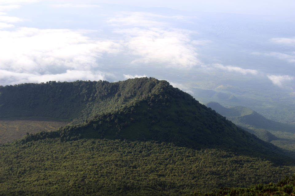 FILE - This Dec. 11, 2016, photo shows the Virunga National Park, taken from the rim of the crater of the Nyiragongo volcano and looking over the crater of another, extinct volcano, in North Kivu Province, in Congo. Parts of Congo's rainforest are up for oil and gas auction and several climate activist groups are petitioning the Pope to support their stance opposing fossil fuels investments. (Juergen Baetz/dpa via AP, File)