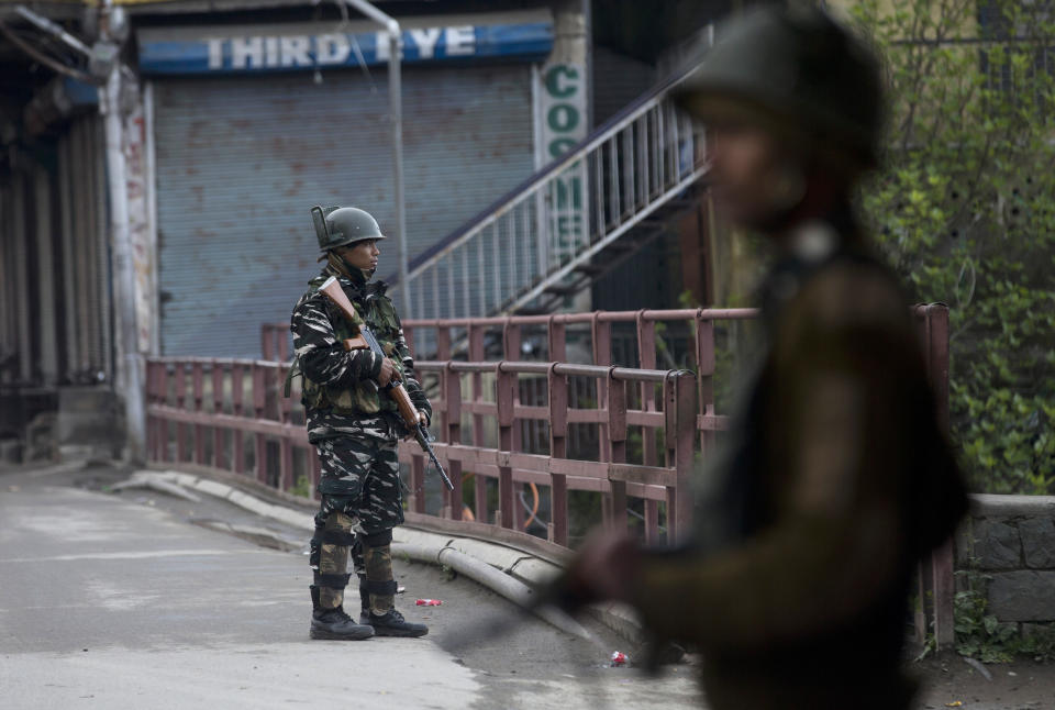 Indian paramilitary soldiers stand guard on a deserted street during the second phase of India's general elections, in Srinagar, Indian controlled Kashmir, Thursday, April 18, 2019. Kashmiri separatist leaders who challenge India's sovereignty over the disputed region have called for a boycott of the vote. Most polling stations in Srinagar and Budgam areas of Kashmir looked deserted in the morning with more armed police, paramilitary soldiers and election staff present than voters. (AP Photo/ Dar Yasin)