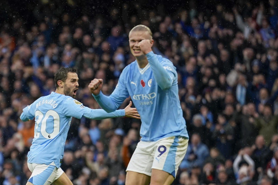 Manchester City's Bernardo Silva, left, and Manchester City's Erling Haaland celebrate with teammates after scoring his side's second goal during the English Premier League soccer match between Manchester City and Bournemouth at the Etihad stadium in Manchester, England, Saturday, Nov. 4, 2023. (AP Photo/Dave Thompson)