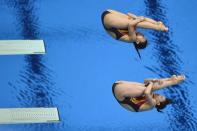 China's Wu Minxia and He Zi dive during the women's synchronised 3m springboard diving event at the London 2012 Olympic Games in London. Wu and He won gold