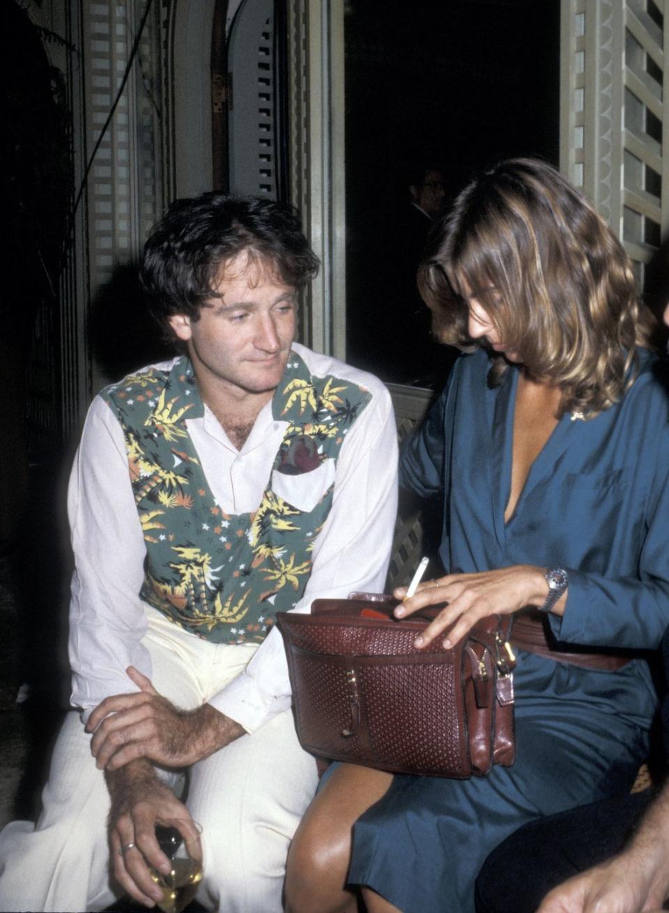 <p>Woven leather purses followed suit after straw bags, as seen here on Valerie Velardi, Robin Williams' then-wife. </p>