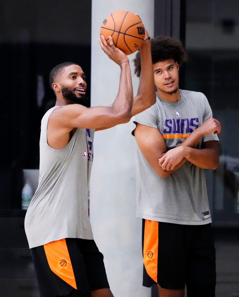 Sep 27, 2022; Phoenix, Arizona, USA; Phoenix Suns forward Mikal Bridges takes a shot as Cameron Johnson watches during practice at the Verizon 5G Performance Center.