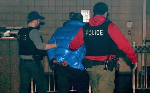 R&B singer R. Kelly is taken into custody after turning himself in at 1st District-Central police station - Credit: Getty