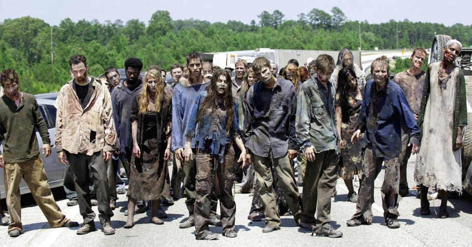 FILE - In this image released by AMC, zombies appear in a scene from the second season of the AMC original series, "The Walking Dead," in Senoia, Ga. The series’ fourth season premieres on Oct. 13. Crews have been filming the new episodes in Georgia, but they keep locations of future episodes closely-guarded secrets until the shows air. In Grantville, Ga., the town’s ruins were featured prominently last season. In nearby Senoia, many scenes are filmed in the historic downtown area, transforming into the fictional town of Woodbury for the show. (AP Photo/AMC, Gene Page) NO SALES