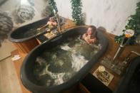 Customers enjoy a beer while relaxing in a jacuzzi full of hot water and a mixture of ingredients used to make beer at the Good Beer Spa in Brussels