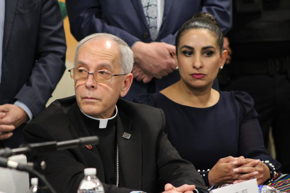 Bishop Mark Seitz of the El Paso Diocese and city Rep. Isabel Salcido listen during a news conference Friday, Feb. 23, 2024, where local leaders denounced a lawsuit filed by Texas Attorney General Ken Paxton against El Paso nonprofit Annunciation House.