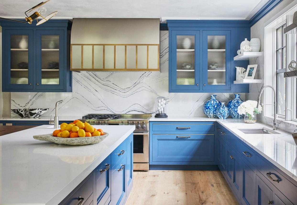 kitchen with blue cabinets and brass accents