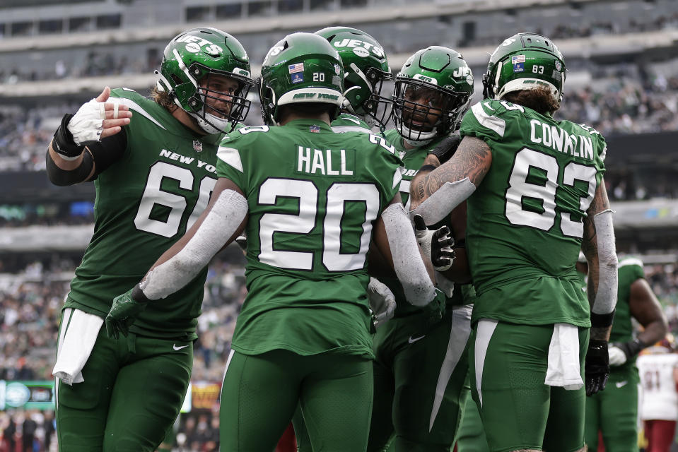 New York Jets running back Breece Hall (20) celebrates with teammates after scoring a touchdown against the Washington Commanders during the second quarter of an NFL football game, Sunday, Dec. 24, 2023, in East Rutherford, N.J. (AP Photo/Adam Hunger)