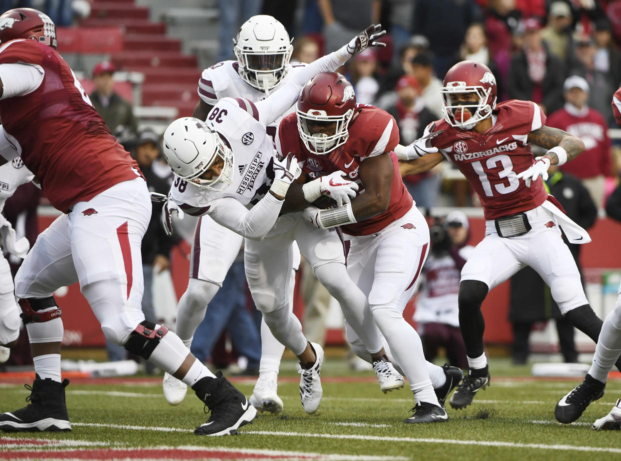 Arkansas David Williams pushes past Mississippi State defender Johnathan Abram to score a touchdown on Saturday. (AP Photo/Michael Woods)