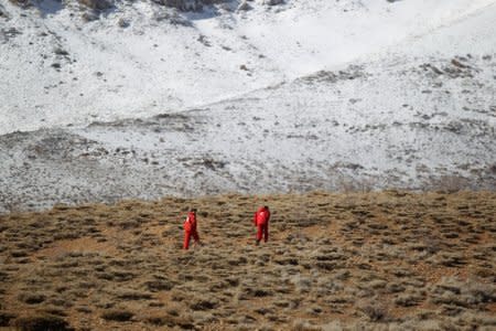 Members of emergency and rescue team search for the plane that crashed in a mountainous area of central Iran, February 19, 2018. REUTERS/Tasnim News Agency