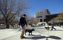 K-9 officers with the Department of Homeland Security patrol outside the federal building in El Paso, Texas, Wednesday, Feb. 8, 2023. Defendant Patrick Crusius pleaded guilty to federal charges accusing him of killing 23 people in the racist attack at an El Paso Walmart in August 2019, changing his plea weeks after the U.S. government said it wouldn't seek the death penalty for the hate crimes and firearms violations. (AP Photo/Andrés Leighton)