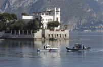 Police officers patrol along the Villa Kerylos in Beaulieu-sur-Mer, southern France, Sunday, March, 24, 2019, where French President Emmanuel Macron and Chinese President Chinese President Xi Jinping will meet. A police boat and police divers worked to secure the area before his arrival, and security cordons blocked several roads in Nice, where Xi will stay overnight. (AP Photo/Claude Paris)