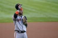 San Francisco Giants shortstop Brandon Crawford tips his cap after being recognized in the first inning of the team's baseball game against the Texas Rangers in Arlington, Texas, Tuesday, June 8, 2021. The game marks Crawford's 1,326th game at shortstop for Giants, breaking a tie for most in team history. (AP Photo/Tony Gutierrez)