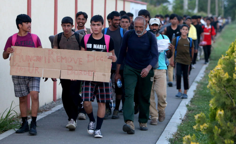 <p>Migrants carry placard as they march on the road near Belgrade to Hungarian border Belgrade, Serbia on July 22, 2016. According to reports, hundreds of migrants from Middle East countries were allegedly moving towards Hungary through the Serbian capital in order to reach western European countries after the Balkan route was effectively closed. (Koca Sulejmanovic/EPA)</p>