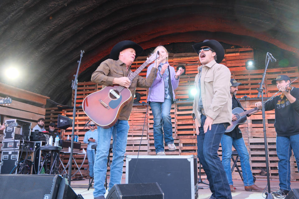 Kevin Fowler, left, and Aaron Watson work with a young girl to stir up the crowd Sunday at the Panhandle Boys: West Texas Relief Concert at the Starlight Ranch in Amarillo.