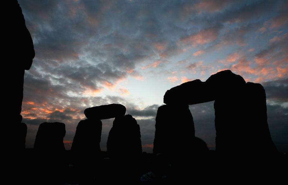 SALISBURY, UNITED KINGDOM - JUNE 21:  Solstice participants wait for the midsummer sun to rise over the megalithic monument of Stonehenge on June 21, 2007 on Salisbury Plain, England. (Photo by Scott Barbour/Getty Images)