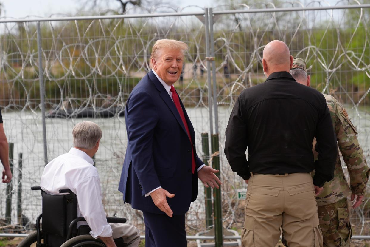 Republican presidential candidate former President Donald Trump gestures after waving to people across the Rio Grande in Mexico at Shelby Park during a visit to the U.S.-Mexico border on Thursday in Eagle Pass, Texas.