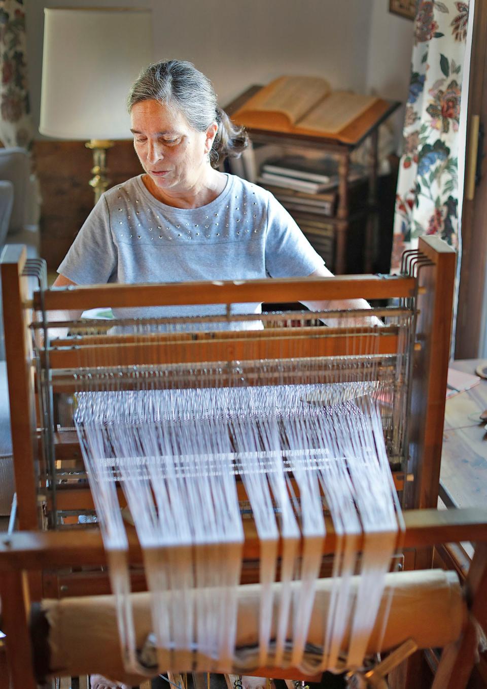 Claire Hassett, owner of Barn Door Arts in Hanover, uses a loom to weave towels, table runners and more from cotton and linen.