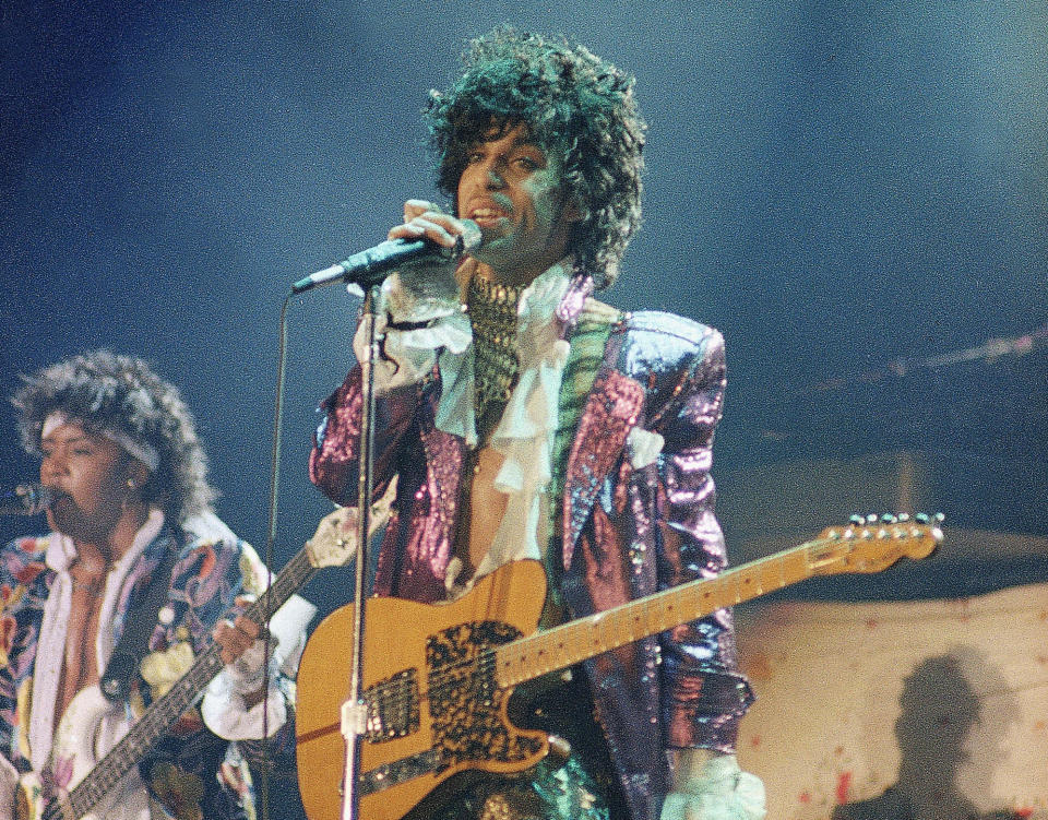 FILE - In this 1985 file photo, singer Prince performs in concert. The Revolution, the band that helped catapult Prince to international superstardom is reuniting in his memory. "Prince: The Beautiful Ones," the memoir Prince started but didn’t finish before his 2016 death, will be released on Tuesday, Oct. 29, 2019. (AP Photo/File)