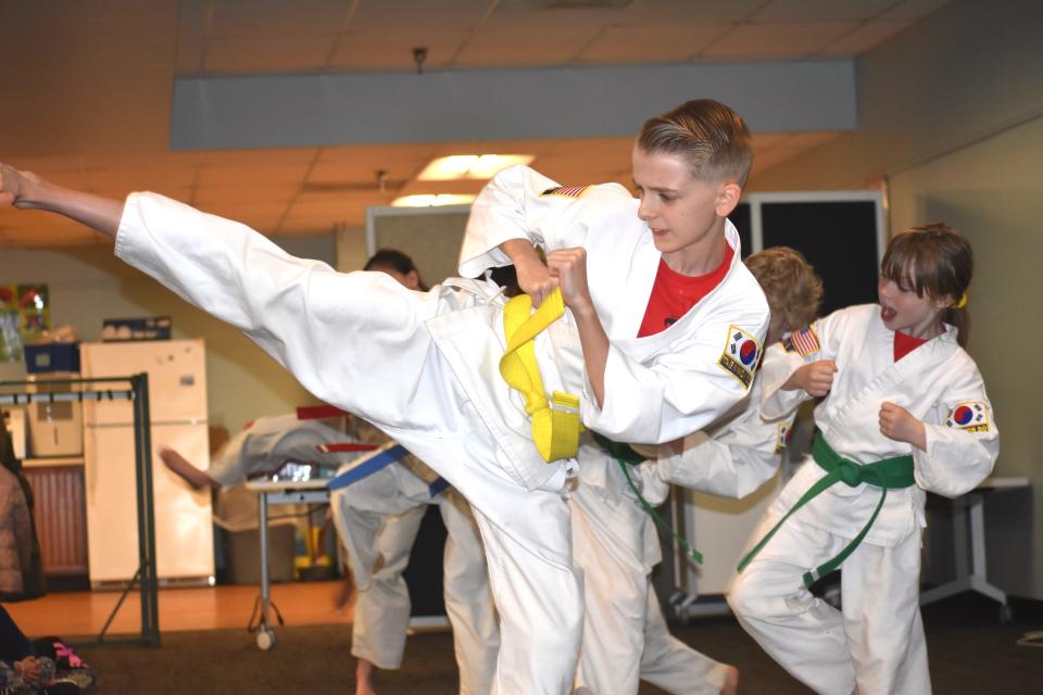 Aiden Voelkle, a student at Black Dragon's Den Martial Arts Academy in Adrian, was one of six students who demonstrated their martial arts skillset during a "Ninja Saturday at the Library" program April 30 at the Adrian District Library. Behind Voelkle with the green belt is Savannah Schettler.
