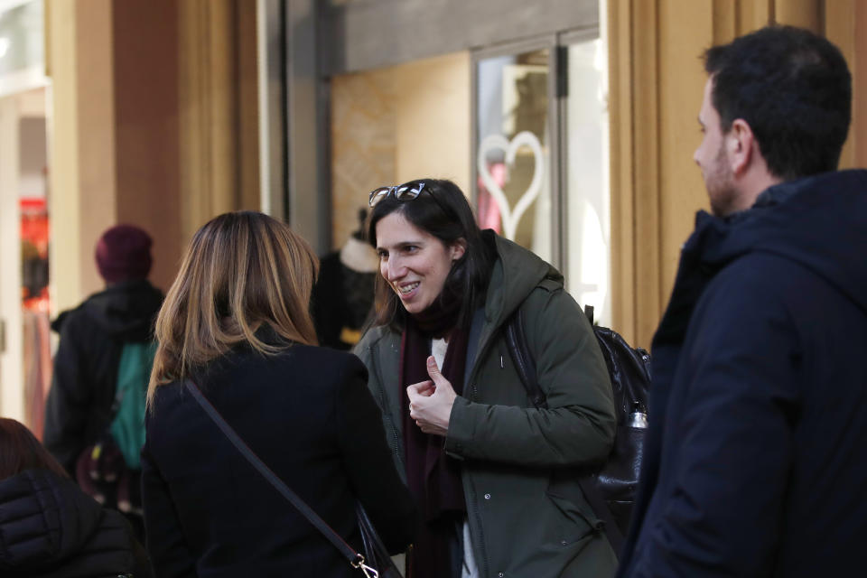 In this photo taken on Thursday, Jan. 30, 2020, Elly Schlein talks with people on a street after an interview with the Associated Press in downtown Bologna, Italy. A dual U.S.-Italian citizen who cut her political organizing teeth on two Barack Obama campaigns is emerging as the latest rising star in Italian politics. (AP Photo/Antonio Calanni)