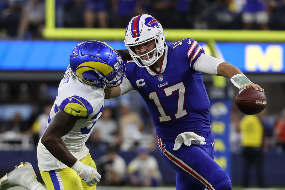 Buffalo Bills quarterback Josh Allen (17) stiff-arms Los Angeles Rams safety Nick Scott (33) during Thursday night's opener. (Photo by Jevone Moore/Icon Sportswire via Getty Images)