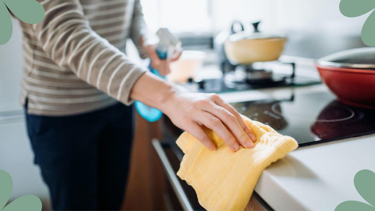   woman wiping counters in a kitchen to support expert guide of dirtiest items in your home 