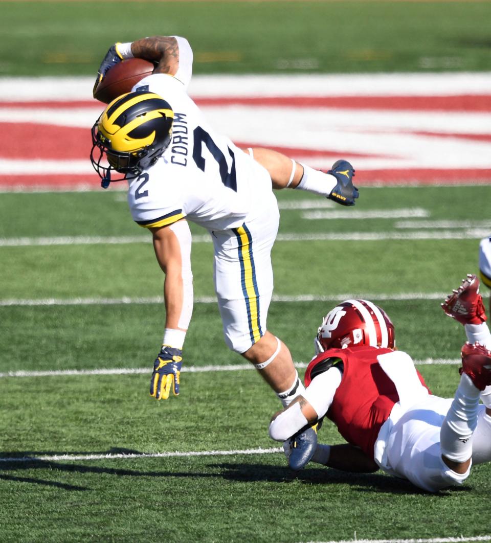 Michigan Wolverines running back Blake Corum (2) is tackled by Indiana Hoosiers defensive back Reese Taylor (2) during the first quarter of the game at Memorial Stadium on Nov 7, 2020 in Bloomington, Indiana.