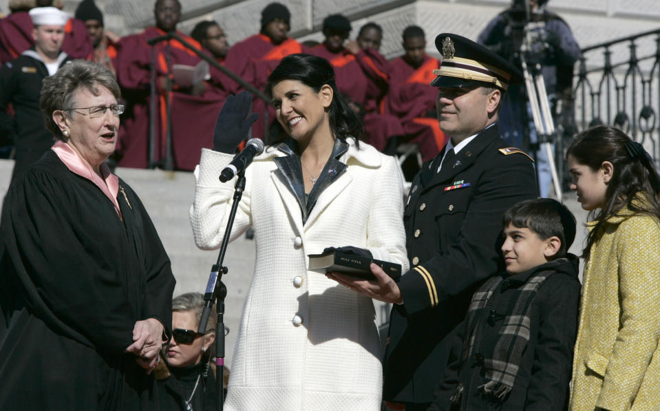 FILE - Nikki Haley takes the oath as Governor of South Carolina, Jan. 12, 2011, at the Statehouse in Columbia, S.C. Chief Justice Jean Toal, left, administers the oath of office as Haley's husband Michael and children Rena and Nalin join her at the podium. (AP Photo/Mary Ann Chastain, File)