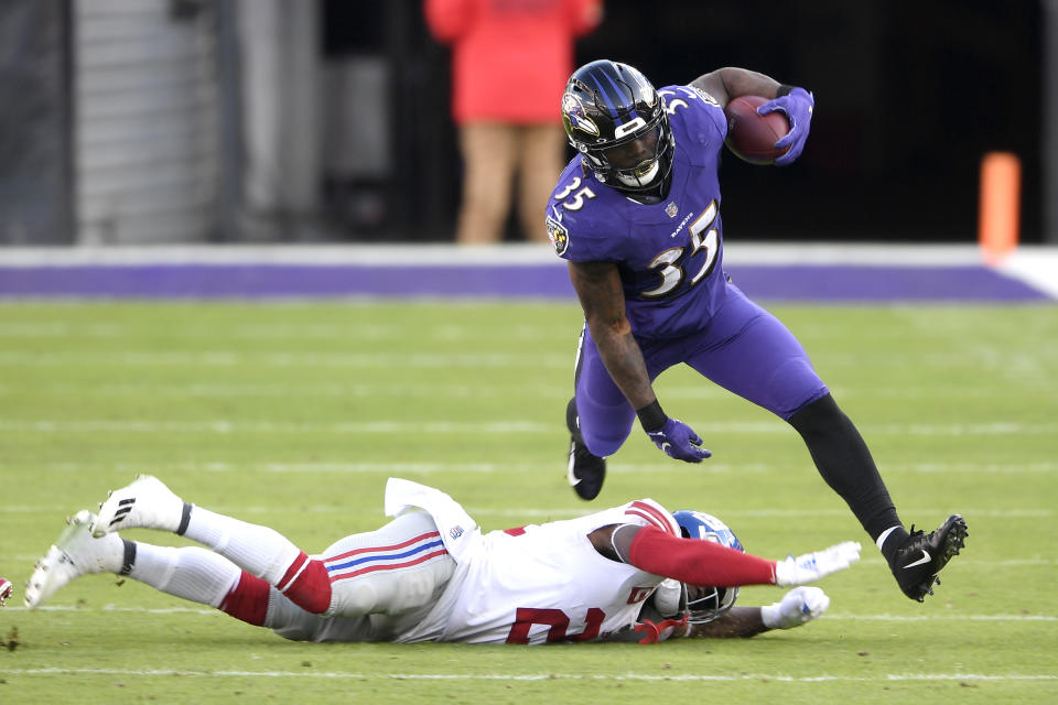 Baltimore Ravens running back Gus Edwards (35) avoids a tackle by New York Giants strong safety Jabrill Peppers (21) during the first half of an NFL football game, Sunday, Dec. 27, 2020, in Baltimore. (AP Photo/Nick Wass)