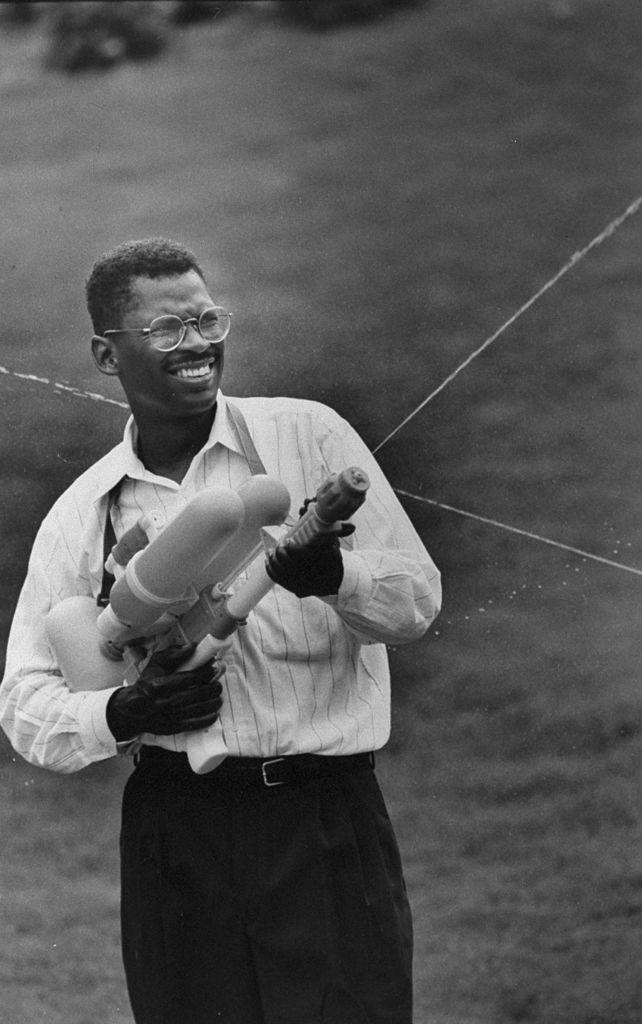 Lonnie smiling and spraying a Super Soaker