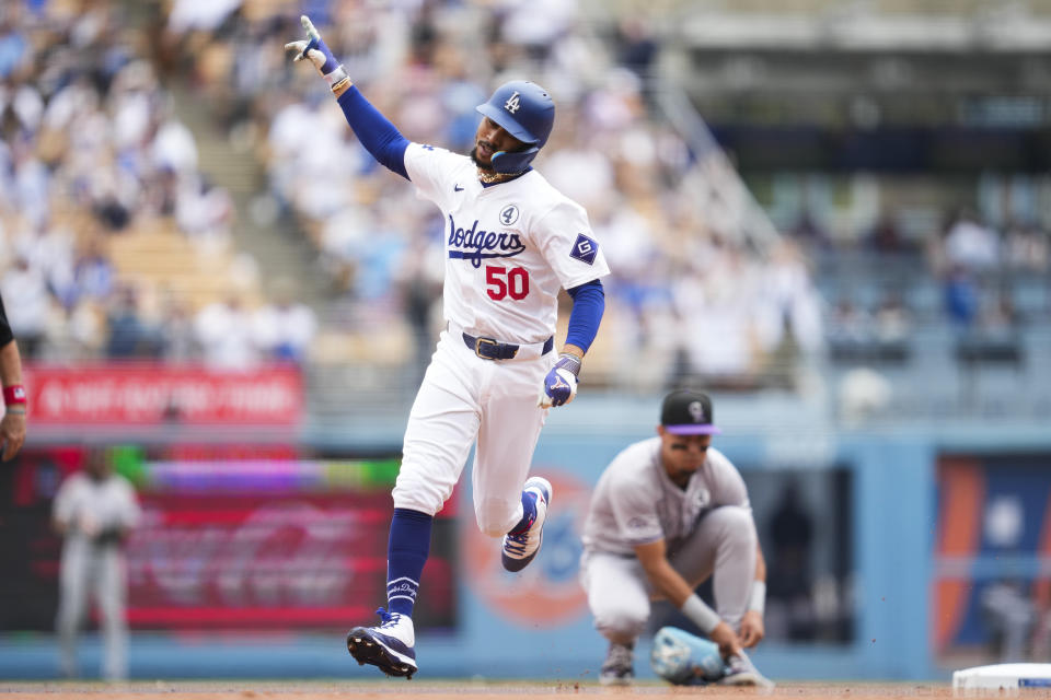 Los Angeles Dodgers' Mookie Betts (50) runs the bases after hitting a home run during the first inning of a baseball game against the Colorado Rockies in Los Angeles, Sunday, June 2, 2024. (AP Photo/Ashley Landis)