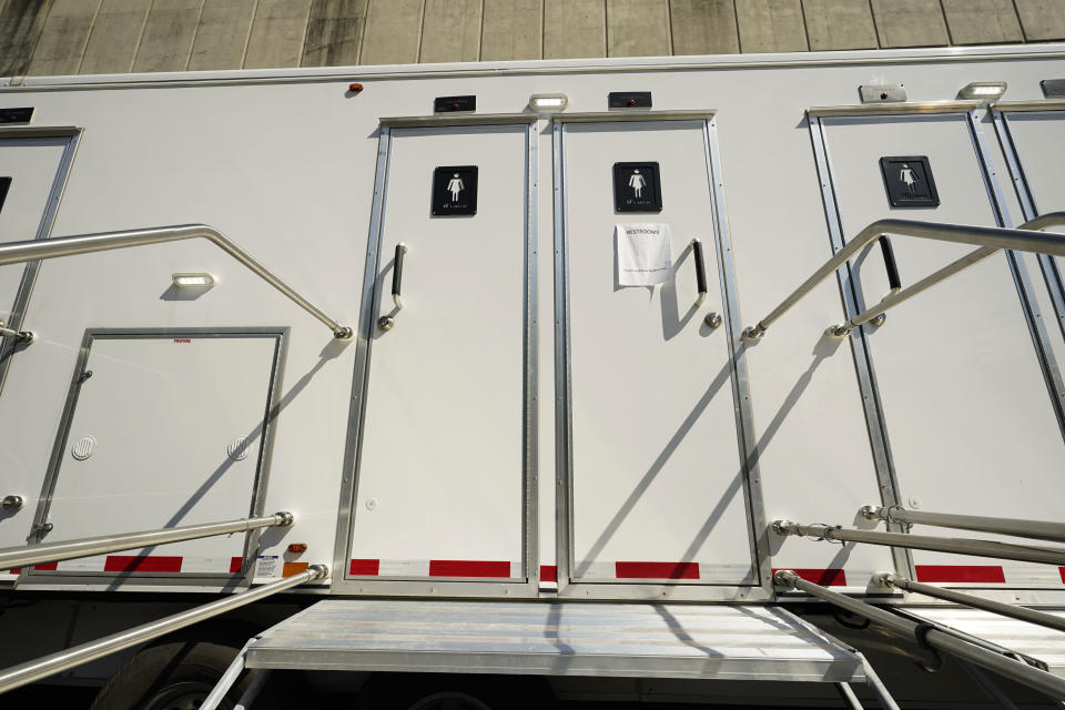 Multi stall portable toilets are are located on the Millsaps College campus to serve the remains 200 students that live in the dorms, in midtown Jackson, Miss., Thursday, Sept. 1, 2022. Erratic water pressure from the water lines in Jackson, are a problem made worse since the recent flooding of the Pearl River affected the city's main water treatment plant in Ridgeland. (AP Photo/Rogelio V. Solis)