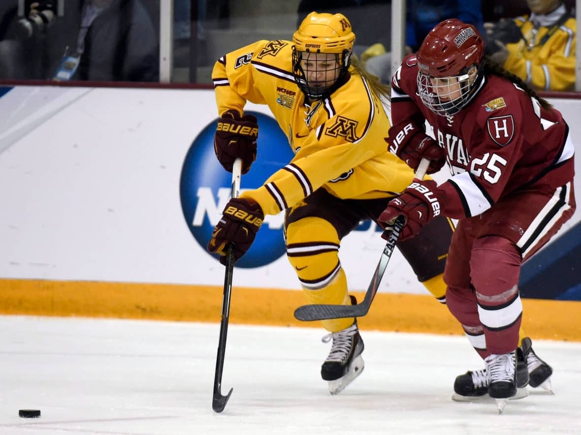 Sydney Daniels, right, chase after the puck in 2015 in Minneapolis. Now that her collegiate playing days are over, Daniels is kicking off a new career as a college scout for the NHL's Winnipeg Jets.  (Hannah Foslien/The Associated Press - image credit)