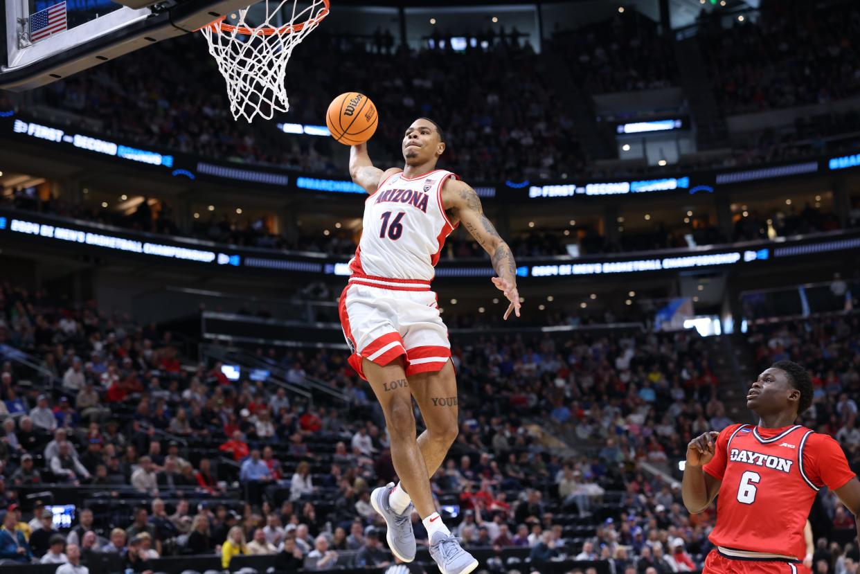 Second round: Arizona Wildcats forward Keshad Johnson dunks against Dayton Flyers guard Enoch Cheeks (6) during the first half of their NCAA Tournament game in Salt Lake City.