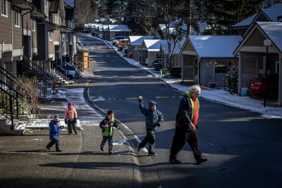 John Bathurst plays with his grandchildren at his Burnaby co-op.