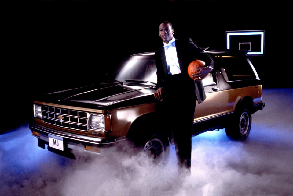 Michael Jordan poses with a Chevrolet Suburban dressed in a tuxedo, in Chicago, Illinois, in 1986. (Photo by Paul Natkin/Getty Images)