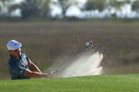 Apr 13, 2018; Hilton Head, SC, USA; Bryson DeChambeau hits from the bunker onto the green of the 18th hole during the second round of the RBC Heritage golf tournament at Harbour Town Golf Links. Mandatory Credit: Joshua S. Kelly-USA TODAY Sports