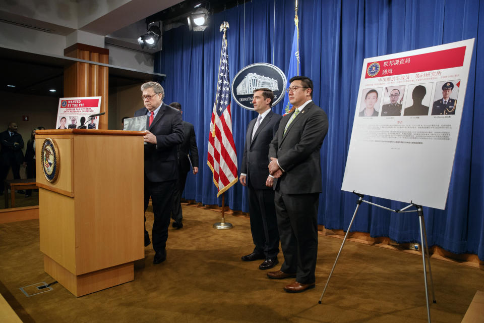 Attorney General William Barr, left, arrives to speak, next to Assistant Attorney General John Demers and U.S. Attorney for the Northern District of Georgia Byung "BJay" Pak, right, during a news conference, Monday, Feb. 10, 2020, at the Justice Department in Washington. Four members of the Chinese military have been charged with breaking into the networks of the Equifax credit reporting agency and stealing the personal information of tens of millions of Americans, the Justice Department said Monday, blaming Beijing for one of the largest hacks in history. (AP Photo/Jacquelyn Martin)