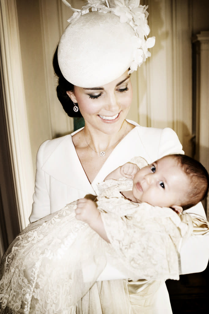 The Duchess of Cambridge in Alexander McQueen holding Princess Charlotte. 