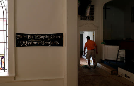 Woody Strickland walks through the sanctuary of Fair Bluff Baptist Church after flooding due to Hurricane Florence receded in Fair Bluff, North Carolina, U.S. September 29, 2018. REUTERS/Randall Hill